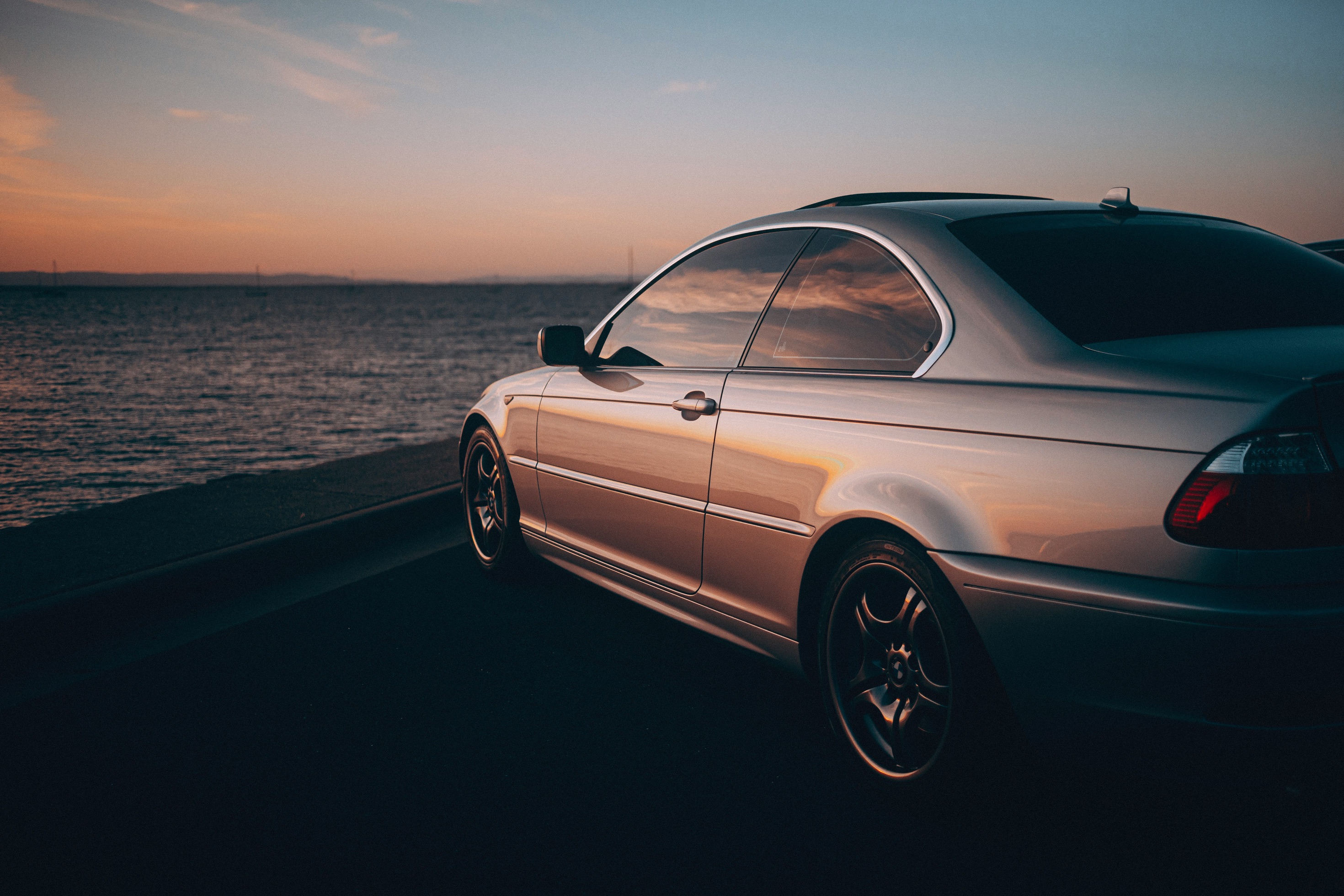 Silver coupe at sunset